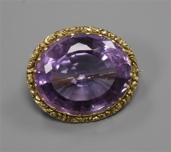 An early 20th century yellow metal mounted oval amethyst brooch, 26mm.